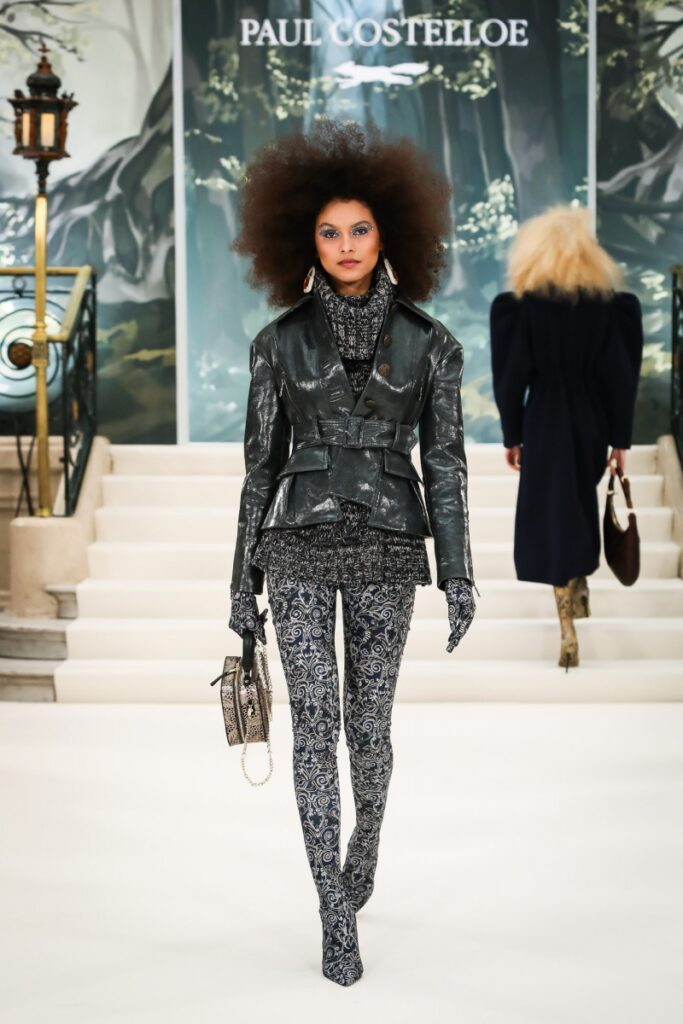 Model wearing hybrid legging boots paired with matching turtleneck and leather jacket at Paul Costelloes London Fashion Week Show.