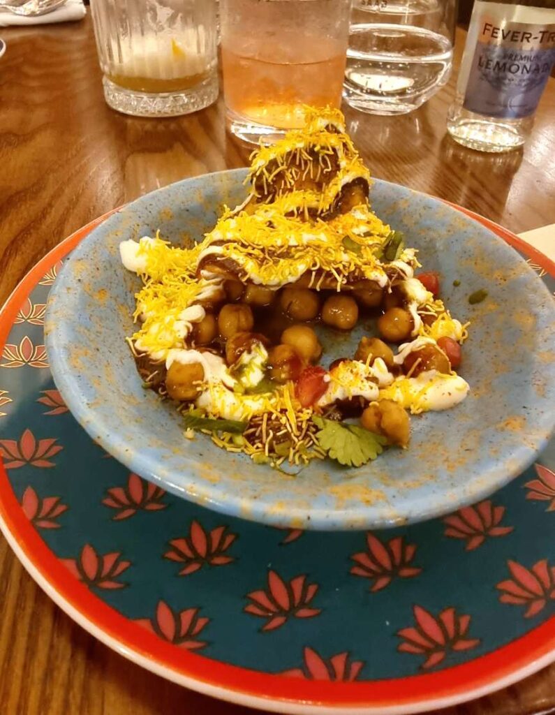 Image of the Purani Dilli ((Mini samosa, masala chickpeas, orange zest, pomegranate) dish at Colonel Saab Restaurant 