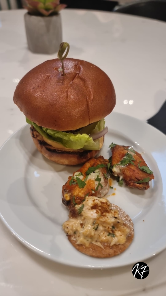 An image of a burger with buffalo wings
