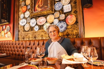 Mrs Doubtfire seating at a table inside Colonel Saab